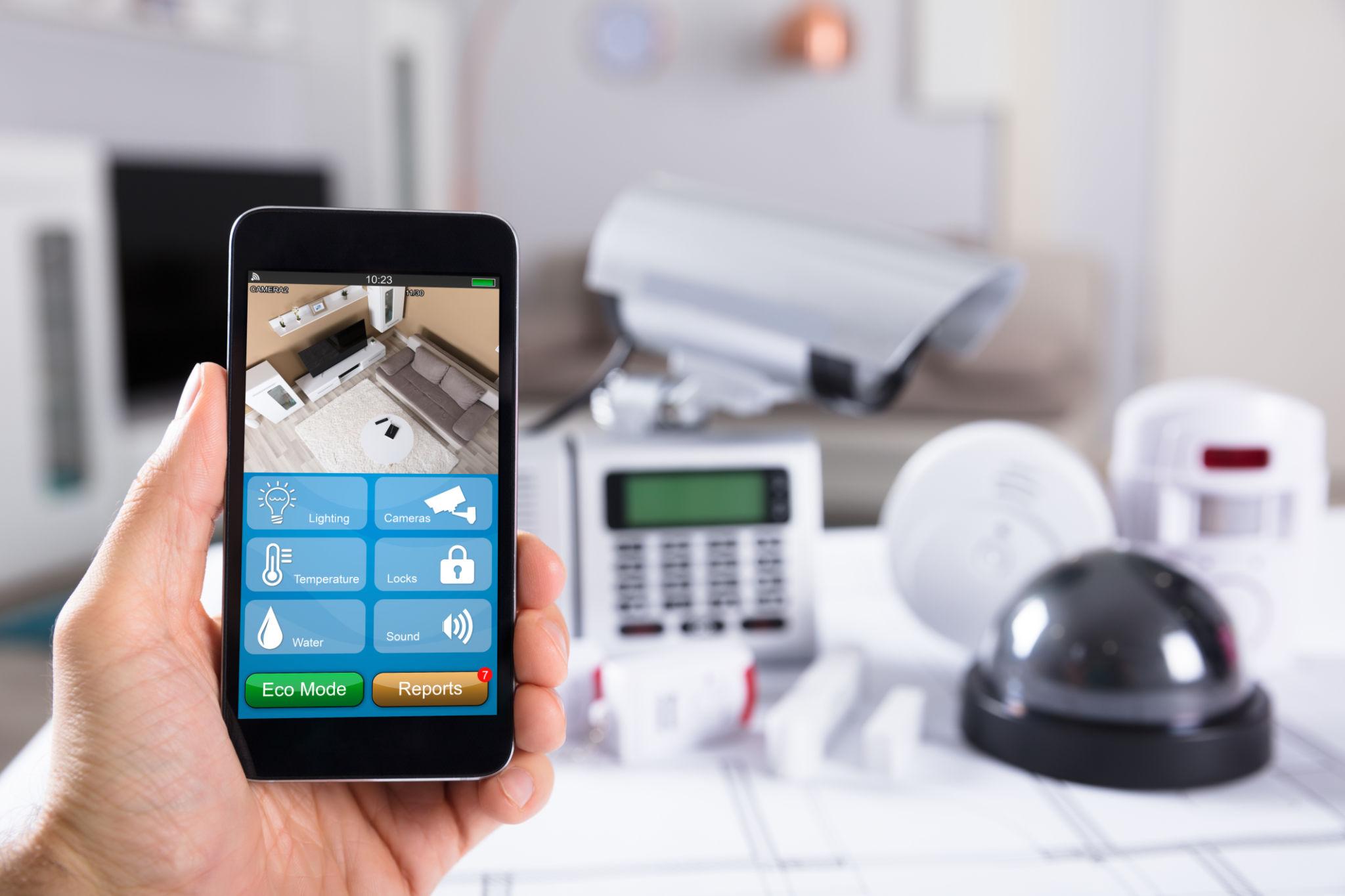 Smart home security system showing mobile app control, cameras, and motion sensors for complete protection.
